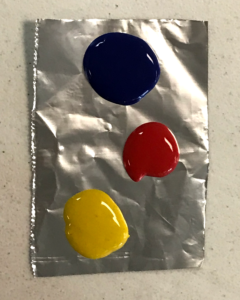 Put the paint on a piece of foil for mixing.