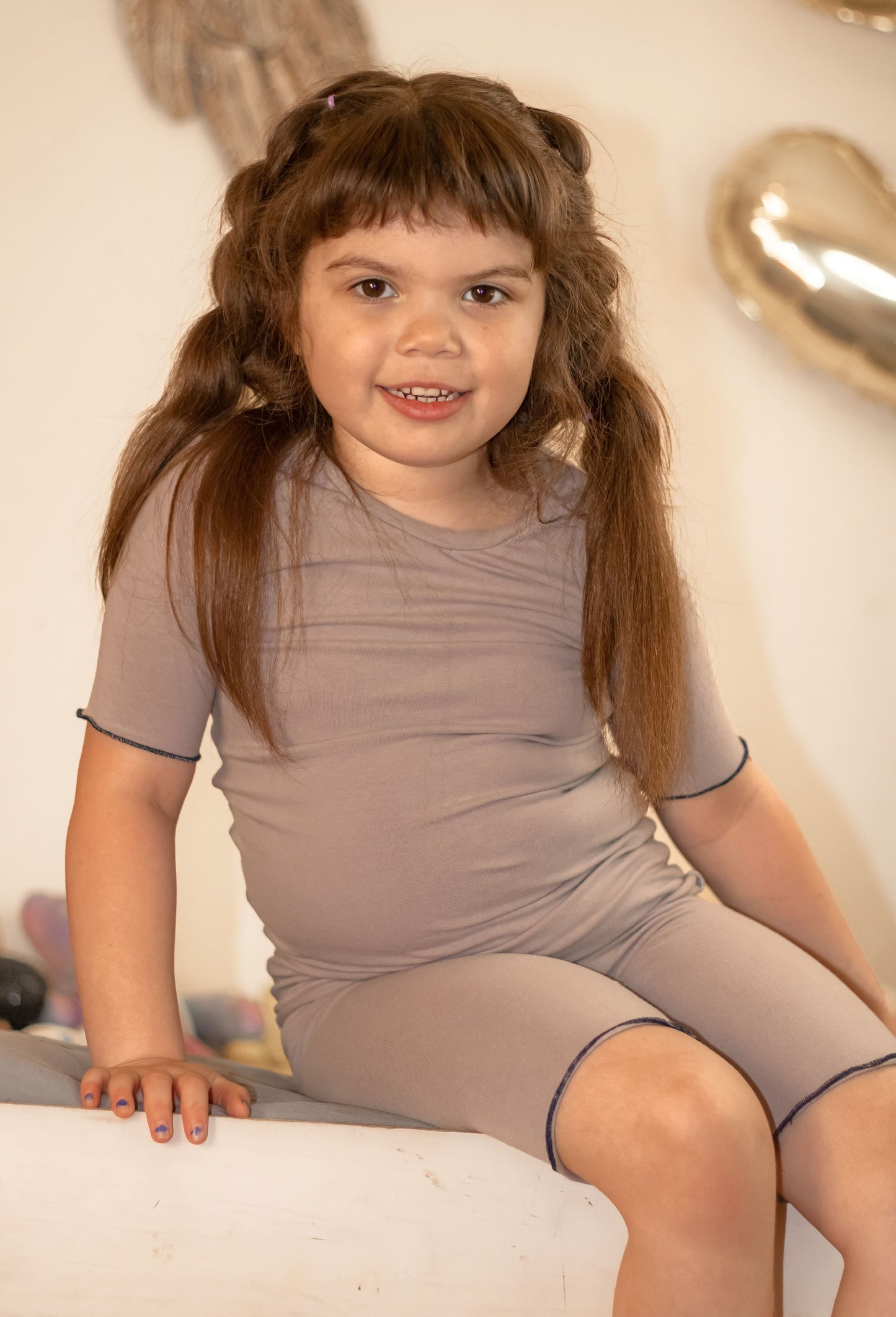 girl wearing gray shortie pajamas