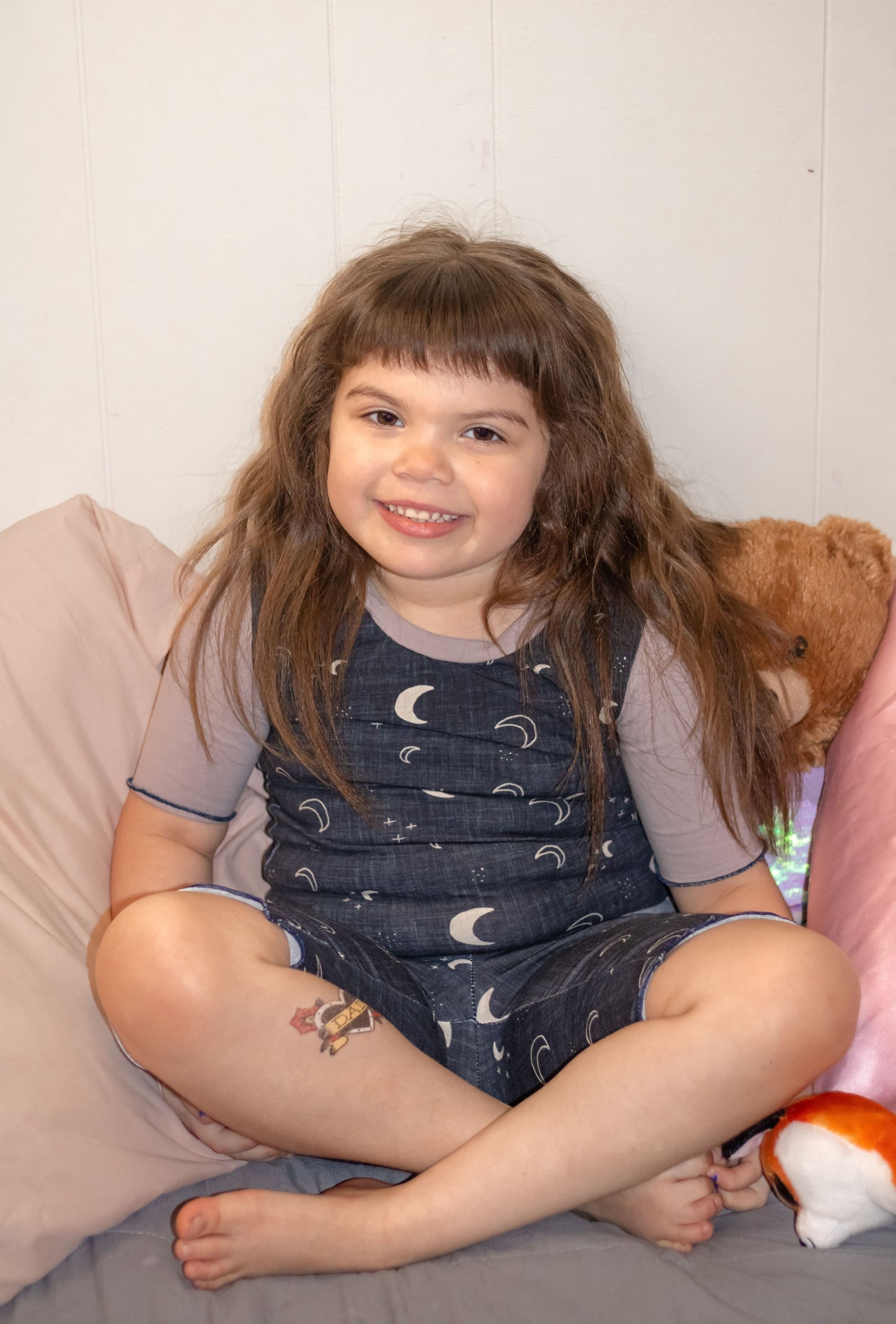 little girl wearing moon and stars shortie pajamas