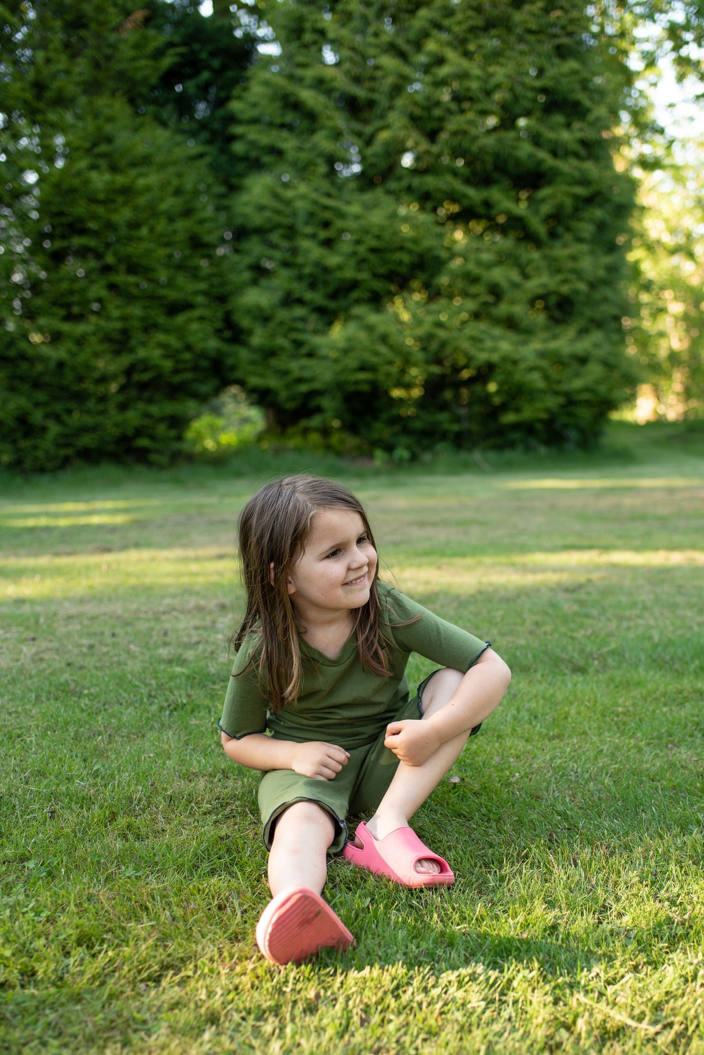 girl wearing olive green shortie pajamas